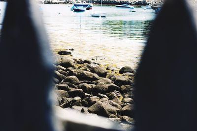 Close-up of pebbles on beach against sky