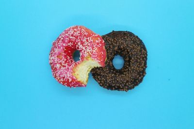 Close-up of cupcake against blue background, donut 