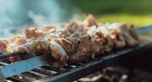 Shish kebab made from chicken and cooked on barbecue grill over charcoal. outdoor food concept.