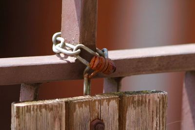 Close-up of chain tied up on metal railing