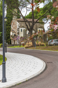 Empty road by buildings in city