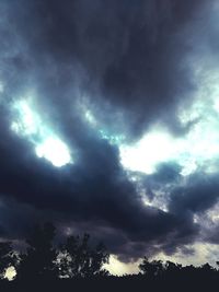 Low angle view of tree against cloudy sky