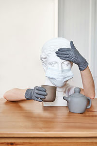 Close-up of person holding umbrella on table