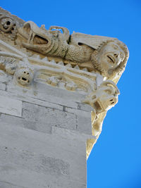 Low angle view of statue against clear blue sky