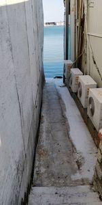 Footpath by sea against sky