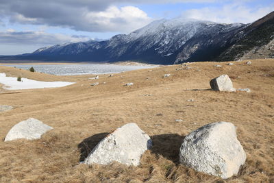 Scenic view of mountains against cloudy sky