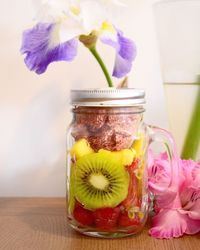 Close-up of flowers in glass vase on table