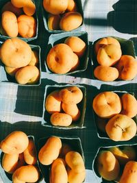 Directly above shot of peaches in box on table for sale in market