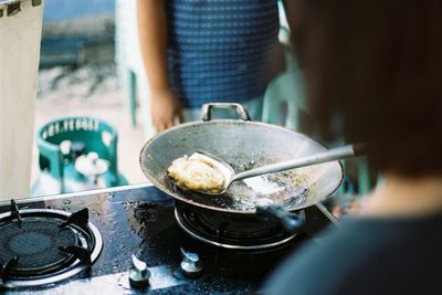 Midsection of woman preparing food in kitchen