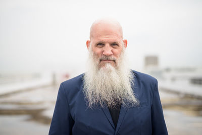 Portrait of man standing against sky