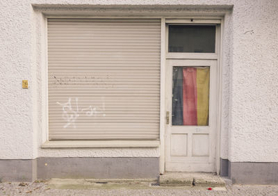 Closed shutter and door of store