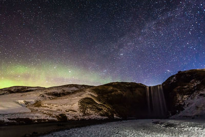 Scenic view of mountain against sky at night