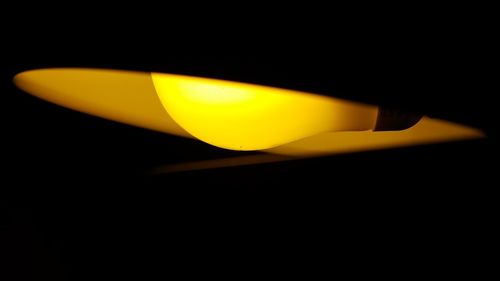 Close-up of illuminated lamp against black background
