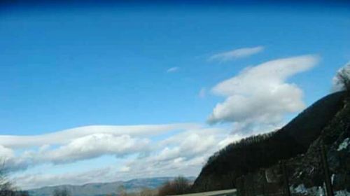 Scenic view of mountains against blue sky