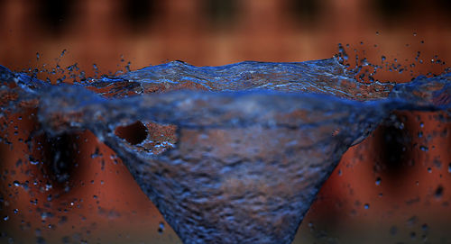 Close-up of water drops on rusty metal