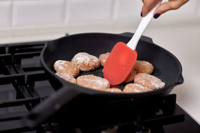 Midsection of person preparing food in kitchen