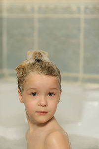 Portrait of shirtless boy in bathroom