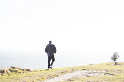 Rear view of a man walking on street