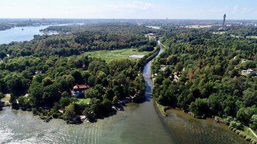 High angle view of river amidst trees against sky