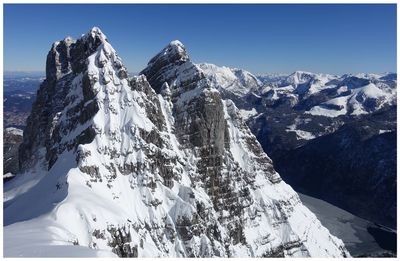 Scenic view of snowcapped mountains against clear sky