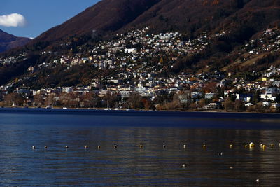 Scenic view of buildings and mountains against sky