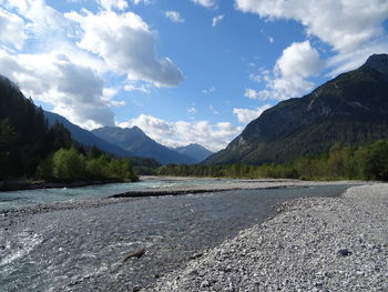 Scenic view of lake and mountains against sky