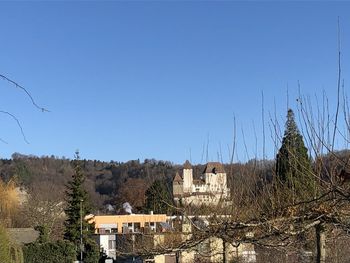 Buildings against clear blue sky