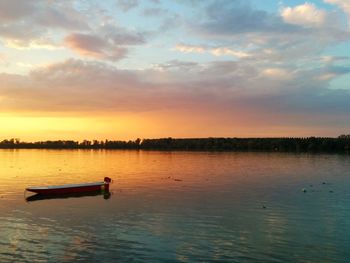 Scenic view of lake at sunset