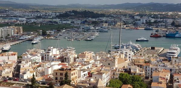 High angle view of harbor and buildings in city