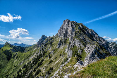 Scenic view of mountains against blue sky