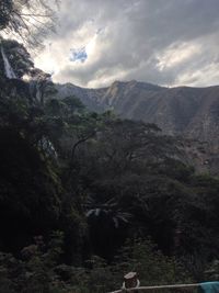 Scenic view of mountains against cloudy sky