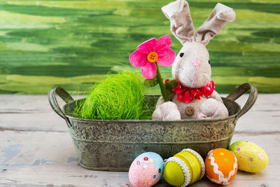 Close-up of stuffed toy with easter eggs on table