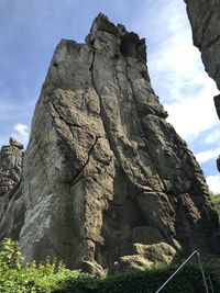 Low angle view of rock formation against sky