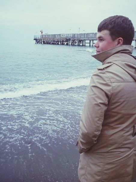 water, sea, lifestyles, leisure activity, beach, person, casual clothing, childhood, pier, full length, shore, standing, boys, elementary age, three quarter length, sitting, sky, rear view