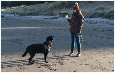 Woman with dog at beach