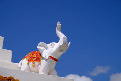 Low angle view of statue against clear blue sky