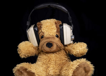 Close-up of stuffed toy against black background