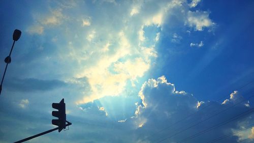 Low angle view of road sign against sky