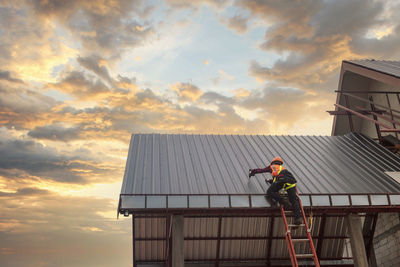 Roofer construction worker install new roof