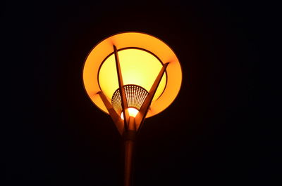 Low angle view of illuminated lamp post at night