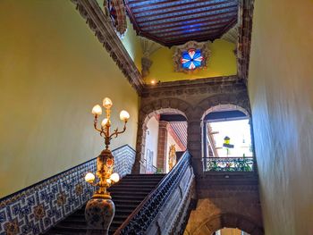 Low angle view of illuminated chandelier in building