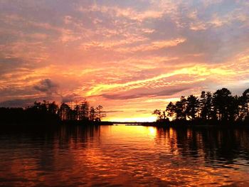 Scenic view of calm lake at sunset