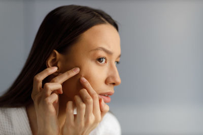 Close-up of young woman looking away