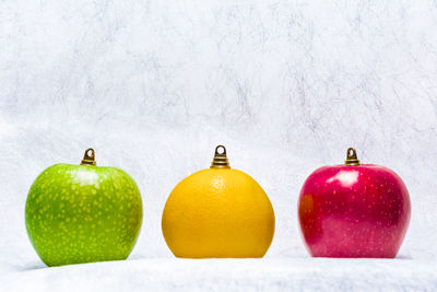 Three fruits represeting colored christmas balls.
