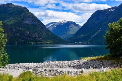 Scenic view of lake and mountains against sky