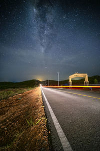 Empty road against sky at night