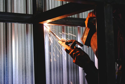 Man holding welding torch in factory