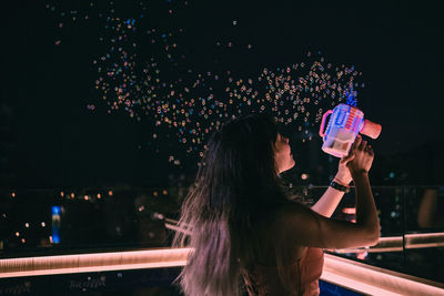 Side view of woman drinking glass