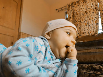 Portrait of cute boy wearing hat at home