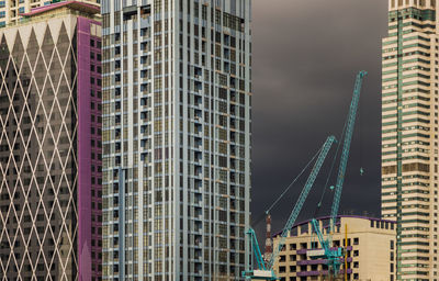Low angle view of modern buildings in city against sky